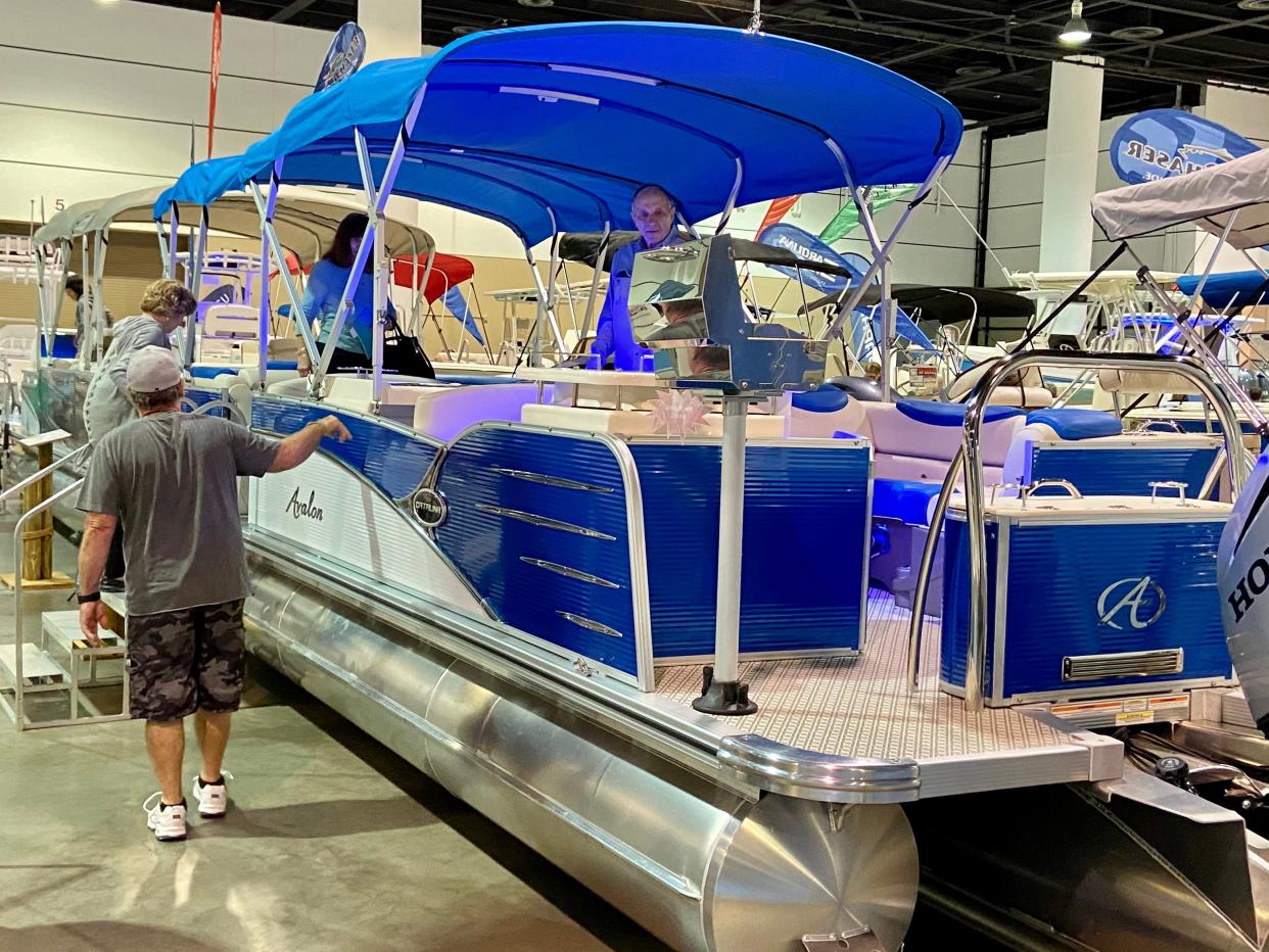 Visitors check out an Avalon pontoon boat during the 2020 Jacksonville Boat Show at the Prime Osborn Convention Center.