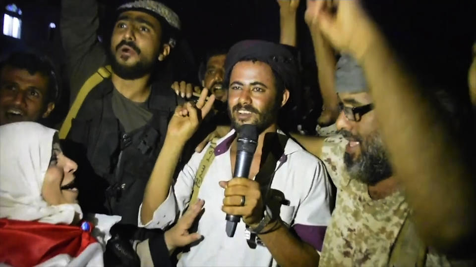 In this Friday Aug. 9, 2019 frame grab from video, Southern Transitional Council separatist fighters and supporters celebrate the storming of the presidential palace in the southern port city of Aden, Yemen. The separatists backed by the United Arab Emirates began withdrawing Sunday from positions they seized from the internationally-recognized government in Aden. Both the southern separatists and the government forces are ostensibly allies in the Saudi-led military coalition that’s been battling the Houthi rebels in northern Yemen since 2015, but the four days of fighting in Aden have exposed a major rift in the alliance. (AP Photo)