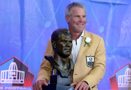 Aug 6, 2016; Canton, OH, USA; Former Green Bay quarterback Brett Favre stands with his bust during the 2016 NFL Hall of Fame enshrinement at Tom Benson Hall of Fame Stadium. Mandatory Credit: Aaron Doster-USA TODAY Sports