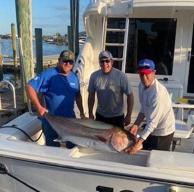 Anthony Petracca, left, with Captains Jon Zeller and Chris Foreman, with the 85.3-pound amberjack Petracca caught offshore aboard Zeller's "Joker."