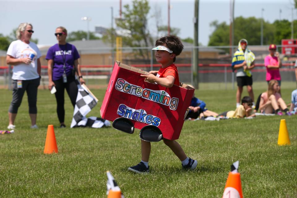 A Mayflower Mill Elementary School kindergartener runs around Mayflower Mill Elementary School's Kindy 500 course set up in McCutcheon High School’s soccer field, on Monday, May 22, 2023, in Lafayette, Indiana.