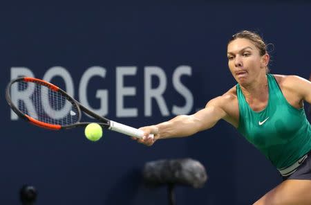 Aug 8, 2018; Montreal, Quebec, Canada; Simona Halep of Romania hits a shot against Anastasia Pavlyuchenkova of Russia (not pictured) during the Rogers Cup tennis tournament at IGA Stadium. Mandatory Credit: Jean-Yves Ahern-USA TODAY Sports