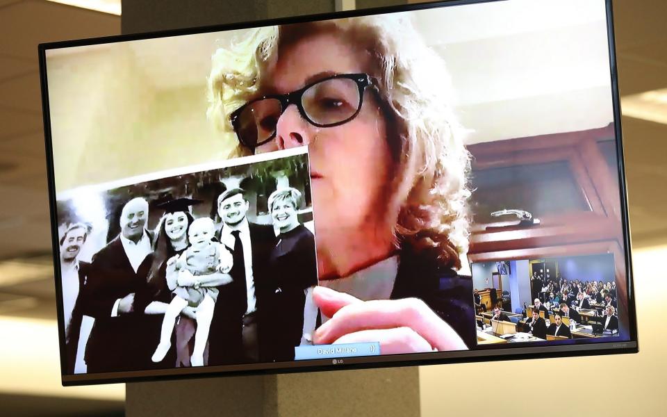Gillian Millane holds a family photograph during her televised victim impact statement from her home in the UK on February 21, 2020 - Greg Bowker/Getty Images