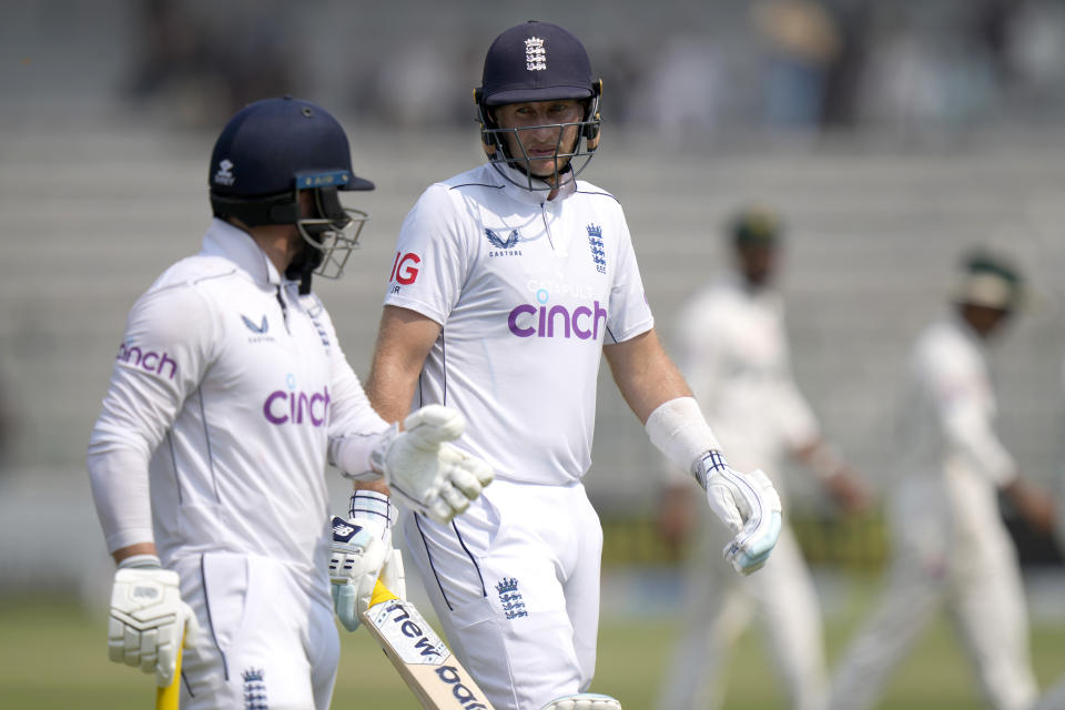 England's Joe Root, right, chat with Ben Duckett as they walk off the field on the lunch break during the third day of the first test cricket match between Pakistan and England, in Multan, Pakistan, Wednesday, Oct. 9, 2024. (AP Photo/Anjum Naveed)