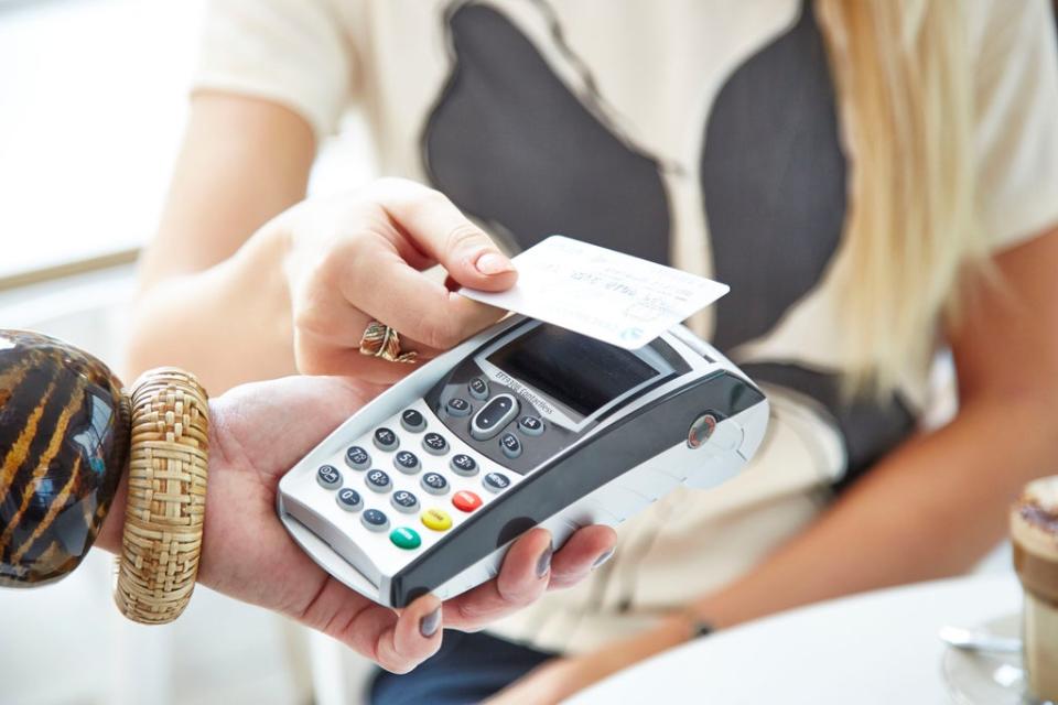 A customer paying for coffee with a contactless card (PA)