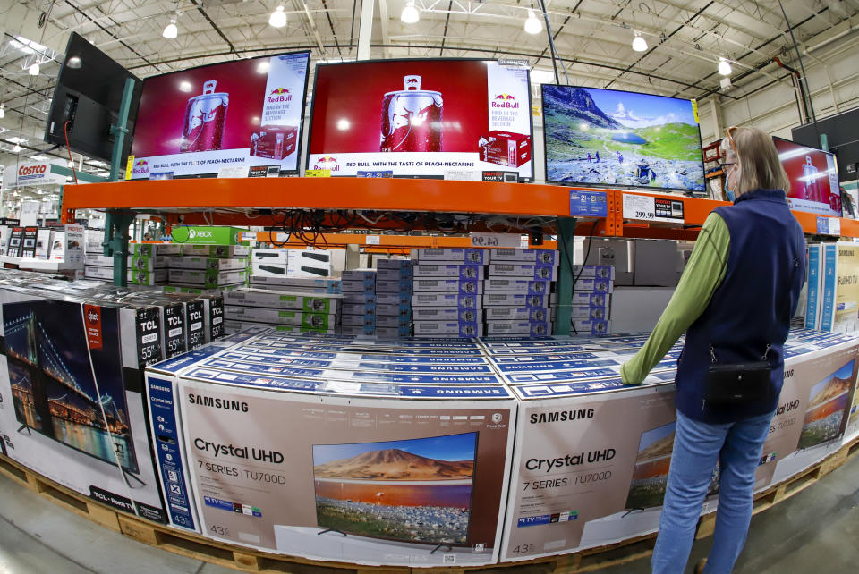 A shopper looks at a display of televisions at a Costco Warehouse in Robinson Township, Pa., on Thursday, May 14, 2020. (AP Photo/Gene J. Puskar)