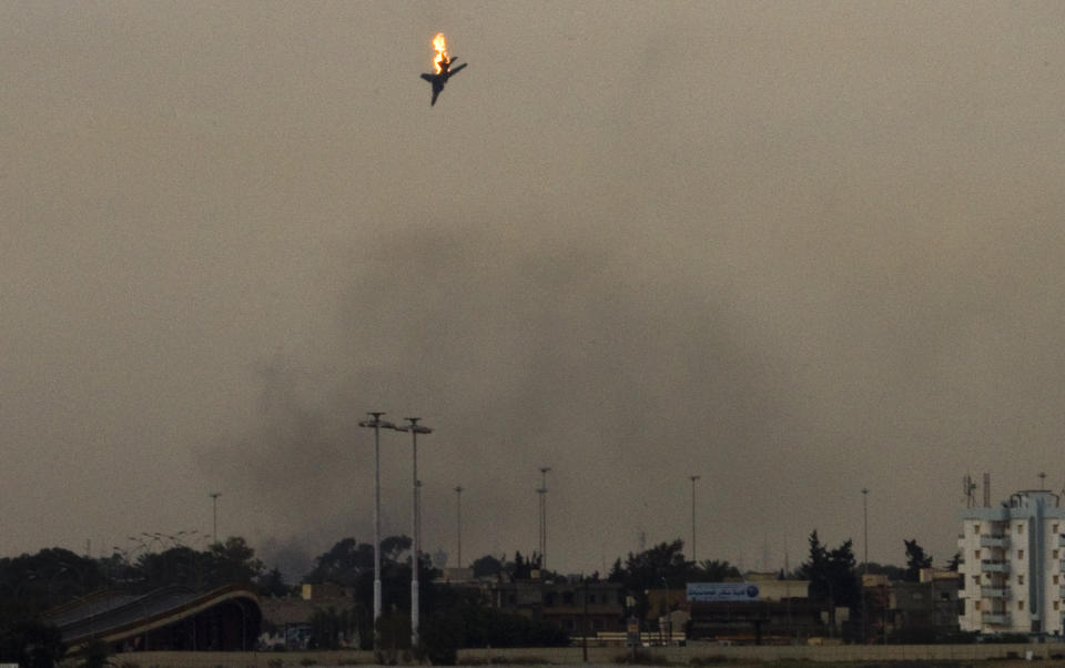 FILE - A war plane is shot down over the outskirts of Benghazi, eastern Libya, Saturday, March 19, 2011. On Friday, Feb. 25, 2022, The Associated Press reported that footage of the plane crashing in Libya in 2011 circulated online with false claims that it was captured during Russia's 2022 invasion of Ukraine. (AP Photo/Anja Niedringhaus)