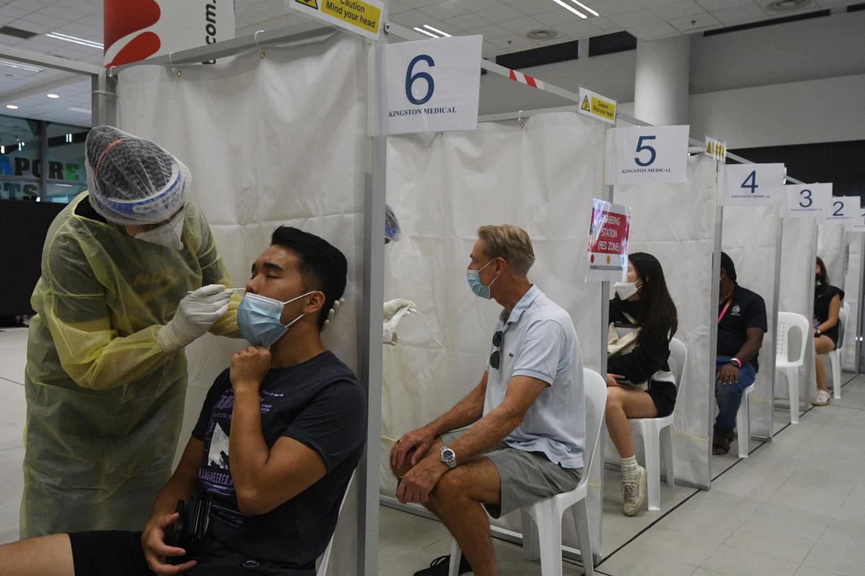 SINGAPORE, Feb. 27, 2021 -- Medical workers take swab samples from spectators for COVID-19 test before the Singapore Tennis Open semifinal in Singapore, Feb. 27, 2021. (Photo by Then Chih Wey/Xinhua via Getty) (Xinhua/Then Chih Wey via Getty Images)