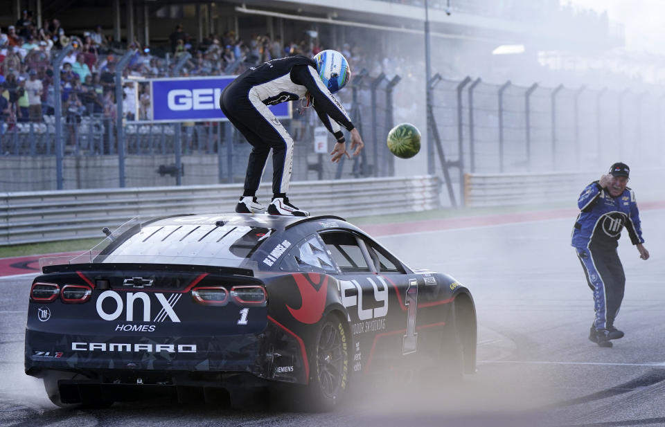 Mar 27, 2022; Austin, Texas, USA; NASCAR Cup Series driver Ross Chastain (1) reacts by smashing a watermelon on the ground after winning the EchoPark Automotive Texas Grand Prix at Circuit of the Americas. Mandatory Credit: Mike Dinovo-USA TODAY Sports