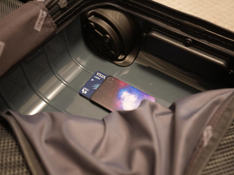 debit cards inside the lining of a hardshell suitcase