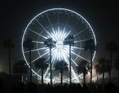 Concertgoers walk by the ferris wheel at the Coachella Valley Music and Arts Festival in Indio, California April 13, 2014. REUTERS/Mario Anzuoni (UNITED STATES - Tags: ENTERTAINMENT)