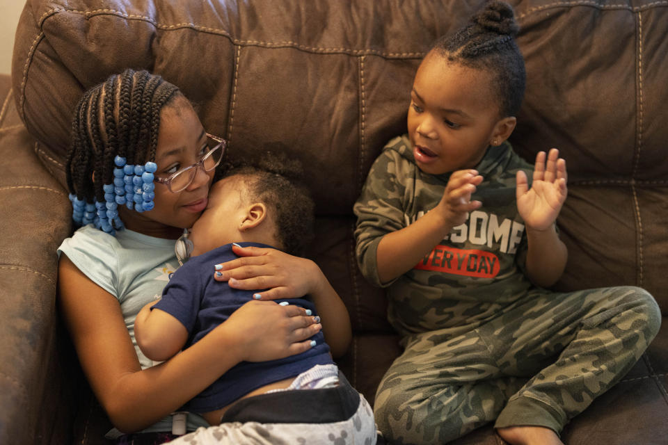 Ke'Arrah Jessie, 9, spends time with her brothers, Khaidyn, 1, and Kairo, 3, while at home during Spring Break in Niagara Falls, N.Y., on Monday, April 3, 2023. The pandemic cut first grade short for Ke'Arrah. To keep the family safe, her mother kept Ke’Arrah home in second grade, too, even when she had the option to return to school in person two days a week. (AP Photo/Lauren Petracca)