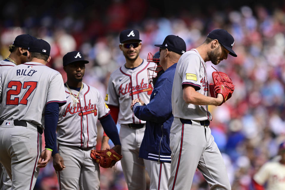 Atlanta Braves starting pitcher Chris Sale, right, leaves during the sixth inning of the team's baseball game against the Philadelphia Phillies, Sunday, March 31, 2024, in Philadelphia. (AP Photo/Derik Hamilton)