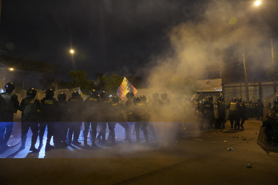 Police block and anti-government march in Lima, Peru, Friday, Jan. 20, 2023. Protesters are seeking the resignation of President Dina Boluarte, the release from prison of ousted President Pedro Castillo and immediate elections. (AP Photo/Guadalupe Pardo)