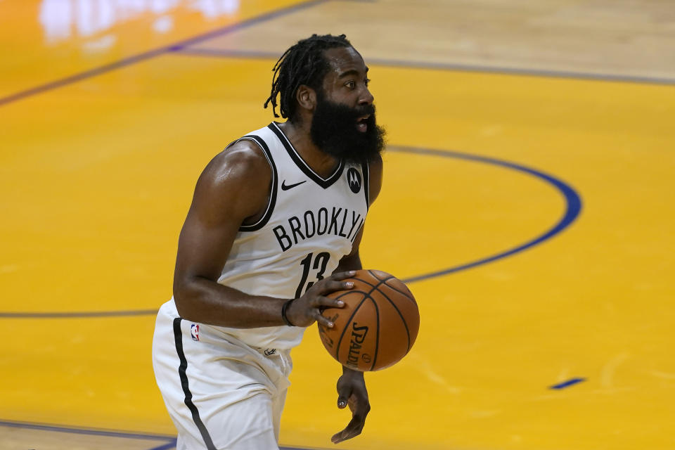 Brooklyn Nets guard James Harden brings the ball up during the first half of the team's NBA basketball game against the Golden State Warriors in San Francisco, Saturday, Feb. 13, 2021. (AP Photo/Jeff Chiu)