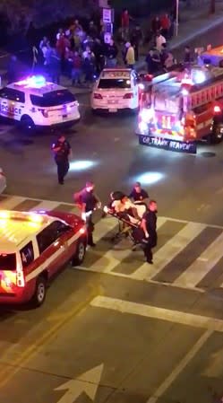 A person is wheeled out on a stretcher following a shooting in Washington