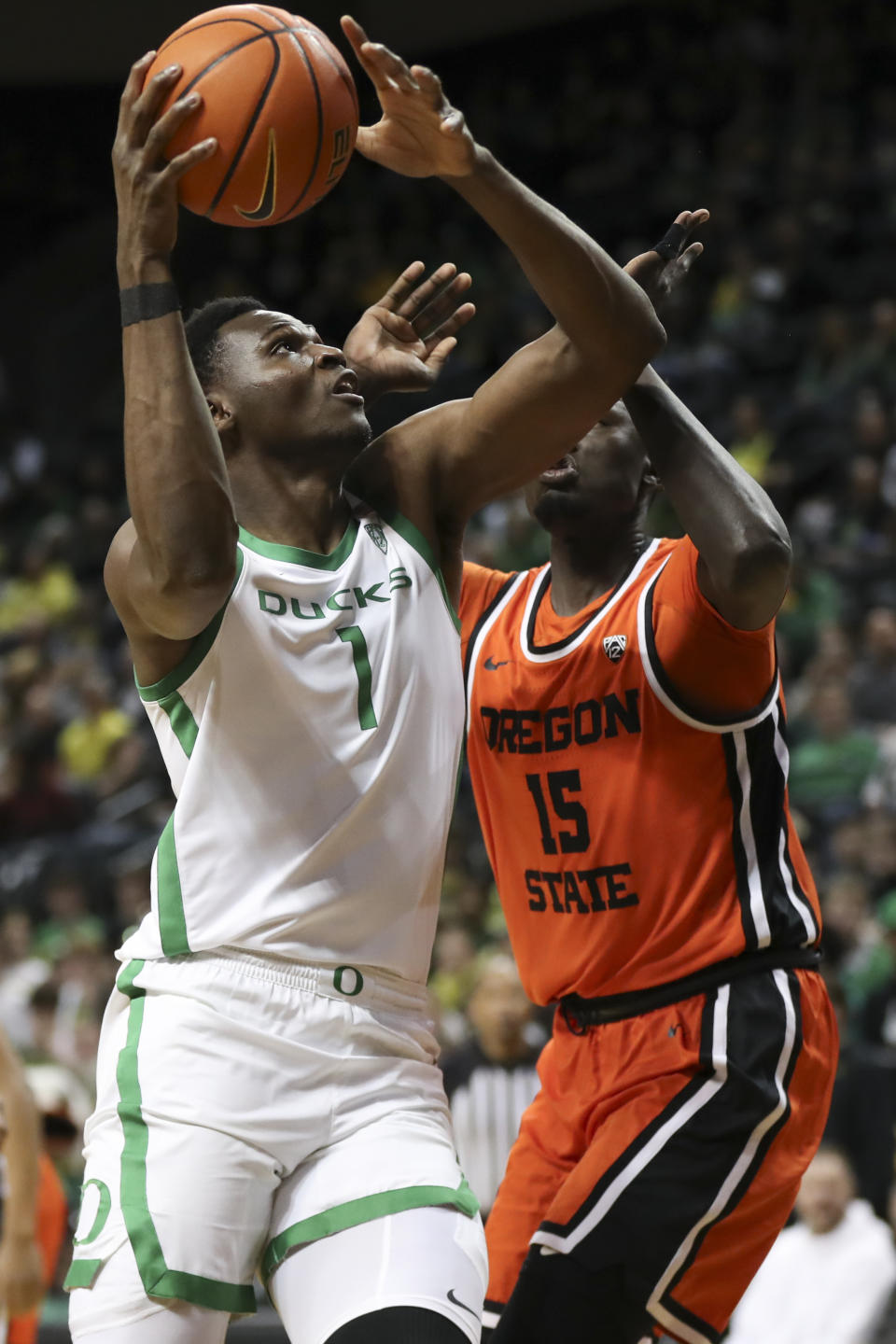 Oregon center N'Faly Dante (1) drives to the basket as Oregon State center Chol Marial (15) defends during the first half of an NCAA college basketball game Wednesday, Feb. 28, 2024, in Eugene, Ore. (AP Photo/Amanda Loman)