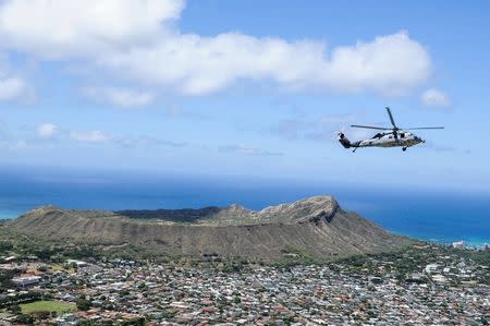 An MH-60S Sea Hawk helicopter participates in a helicopter training exercise over Diamond Head crater on the Hawaiian island of Oahu in this July 3, 2014 handout photo obtained by Reuters July 6, 2017. Ensign Joseph Pfaff/U.S. Navy/Handout via REUTERS