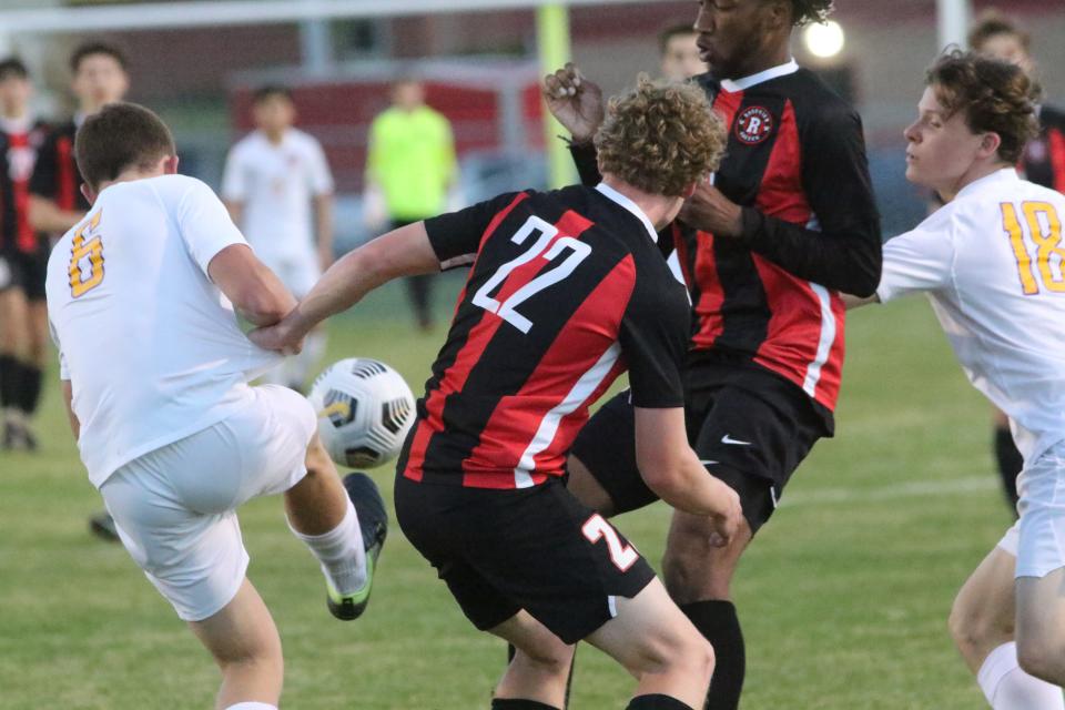 Clarksville's Bryce Duhl (6) kicks the ball away from Rossview's Chance Siler (22) as the Wildcats' Maxwell Sims (18) clears a Rossview player in the first half during their District 13-4A game Wednesday, April 27, 2022 at Rossview High School.