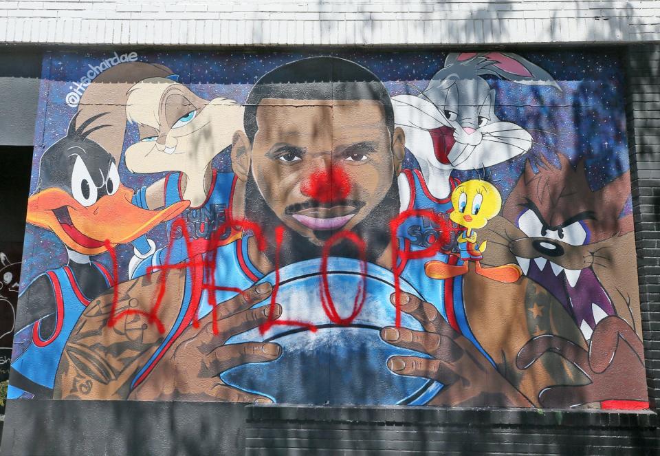 A LeBron James “Space Jam” mural in Akron, Ohio, was defaced by a vandal, who painted a red nose on the face of the NBA star and the words “LA FLOP” across the mural.