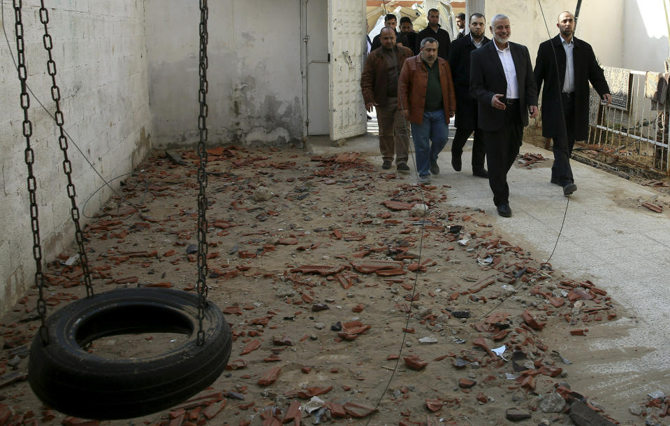 Hamas' supreme leader Ismail Haniyeh tours the site of a destroyed building, in Gaza City, Wednesday, March 27, 2019. Haniyeh made his first public appearance since a new round of cross-border violence with Israel this week. On Wednesday he visited the rubble of his Gaza City office, which was destroyed in an Israeli airstrike. (AP Photo/Adel Hana)