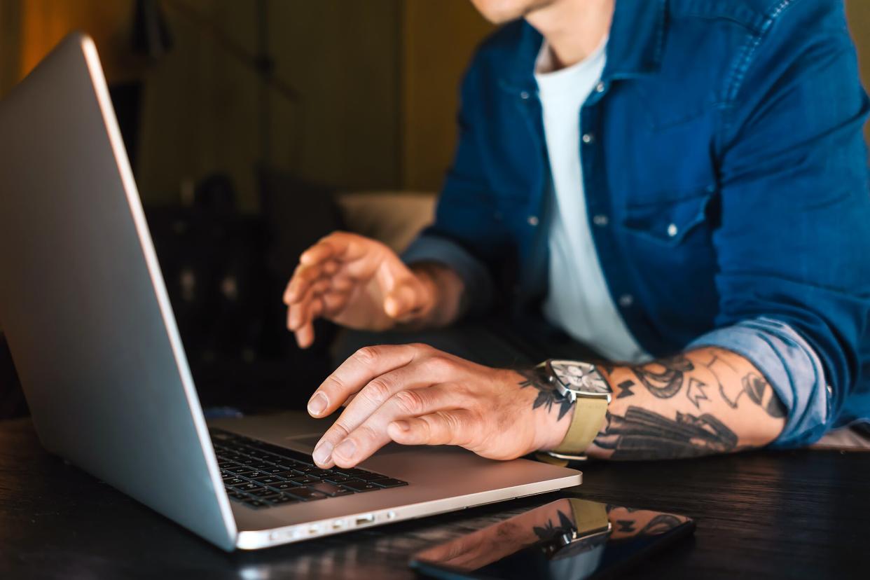 A person types on a laptop