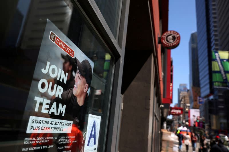 FILE PHOTO: A sign for hire is posted on the window of a restaurant in New York City