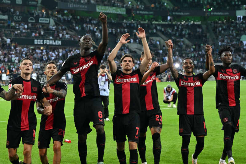 Leverkusen's Honas Hofmann (4-L) celebrates with teamamtes after the German Bundesliga soccer match between Borussia Moenchengladbach and Bayer Leverkusen. Hofmann has admitted that the current successful run of the Bundesliga leaders is almost a bit scary. "The success is carrying us at the moment, but the dimension of it is extraordinary," Hofmann said in an interview with the Rheinische Post newspaper. Federico Gambarini/dpa