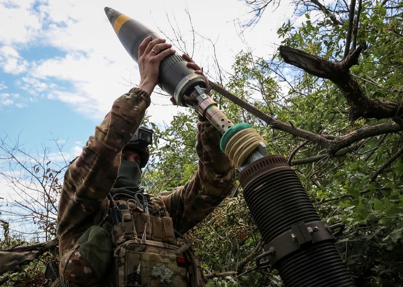FILE PHOTO: Ukrainian service members fire a mortar at a front line near the city of Bakhmut