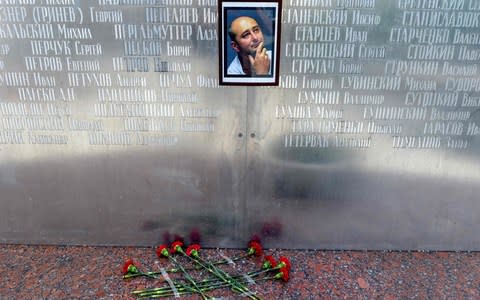 Flowers lay under a picture of Arkady Babchenko in Kiev - Credit: VASILY MAXIMOV /AFP