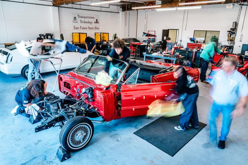 a group of people working on a car