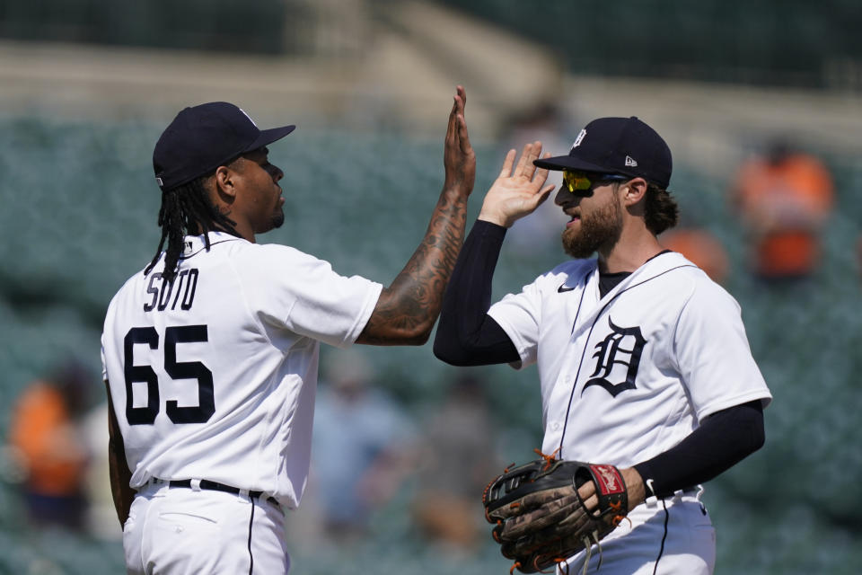 Detroit Tigers relief pitcher Gregory Soto (65) greets left fielder Eric Haase after the team's 8-3 win over the Seattle Mariners in a baseball game, Thursday, June 10, 2021, in Detroit. (AP Photo/Carlos Osorio)