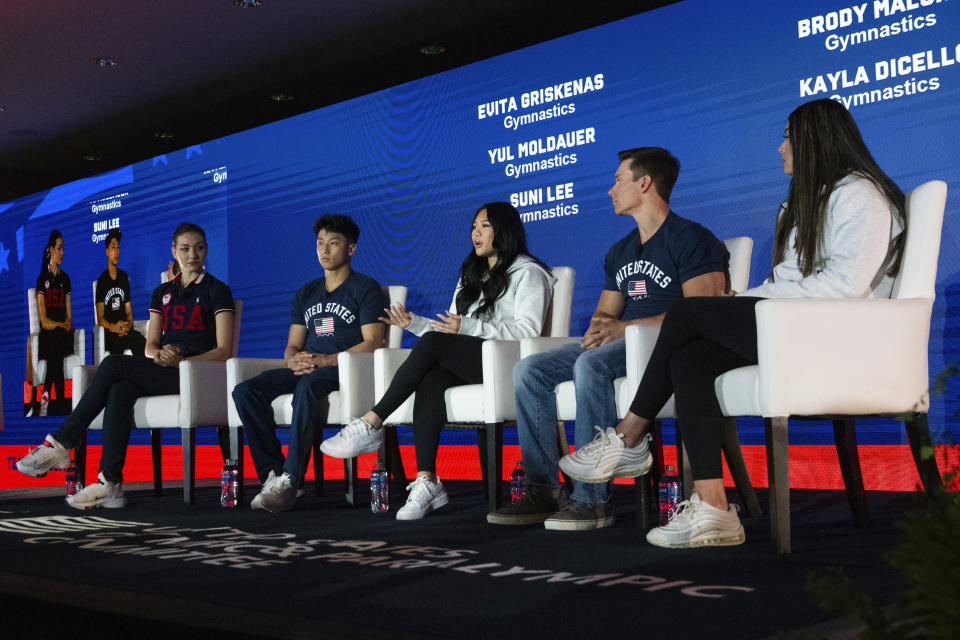 Suni Lee, center, speaks during a press conference at the Team USA Media Summit in New York, Monday, April 15, 2024. From left are gymnasts Evita Griskenas, Yul Moldauer, Lee, Brody Malone and Kayla DiCello. Olympic gymnastics all-around champion Suni Lee revealed this week that at the height of her battle with kidney disease last year, she gained around 45 pounds in water weight that made her question whether a return to top form was even possible. (AP Photo/Brittainy Newman)