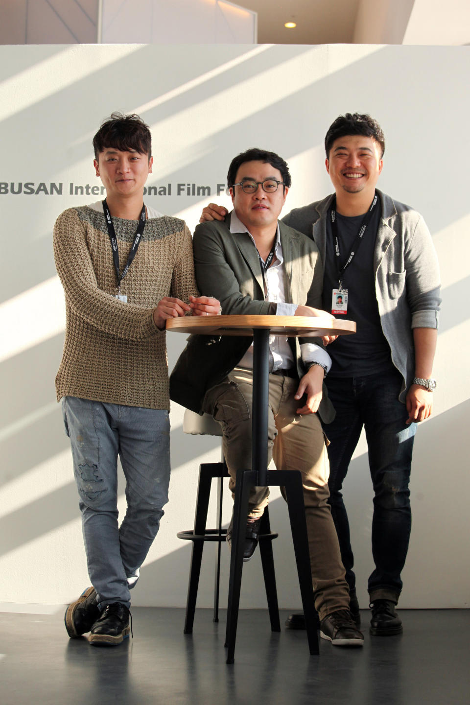 In this Oct.4, 2013 photo, South Korean producer Yoon Ki Ho, left, director Kim Taeyun, center, and producer Park Sung-il of the movie "Another Family" pose during an interview at Busan Cinema Center in Busan, South Korea. “Another Family,” which premiered during the 18th Busan International Film Festival ending on Saturday, is a fictional account based on the story of Hwang Yu-mi, who died at the age of 23 from leukemia in 2007, four years after joining Samsung’s memory chip factory in Yongin, Korea. The title resonates widely in South Korea because it is a well-known Samsung advertising slogan. (AP Photo/Woohae Cho)