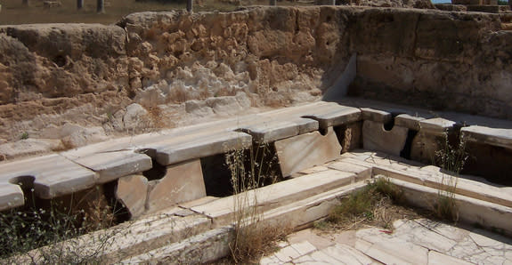 The remains of Roman latrines in Leptis Magna, Libya.