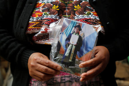 Lidia Gonzalez holds a picture of her daughter Claudia Gomez, a 19-year old Guatemalan immigrant who was shot by an U.S. Border Patrol officer, at her home in San Juan Ostuncalco, Guatemala May 27, 2018. REUTERS/Luis Echeverria