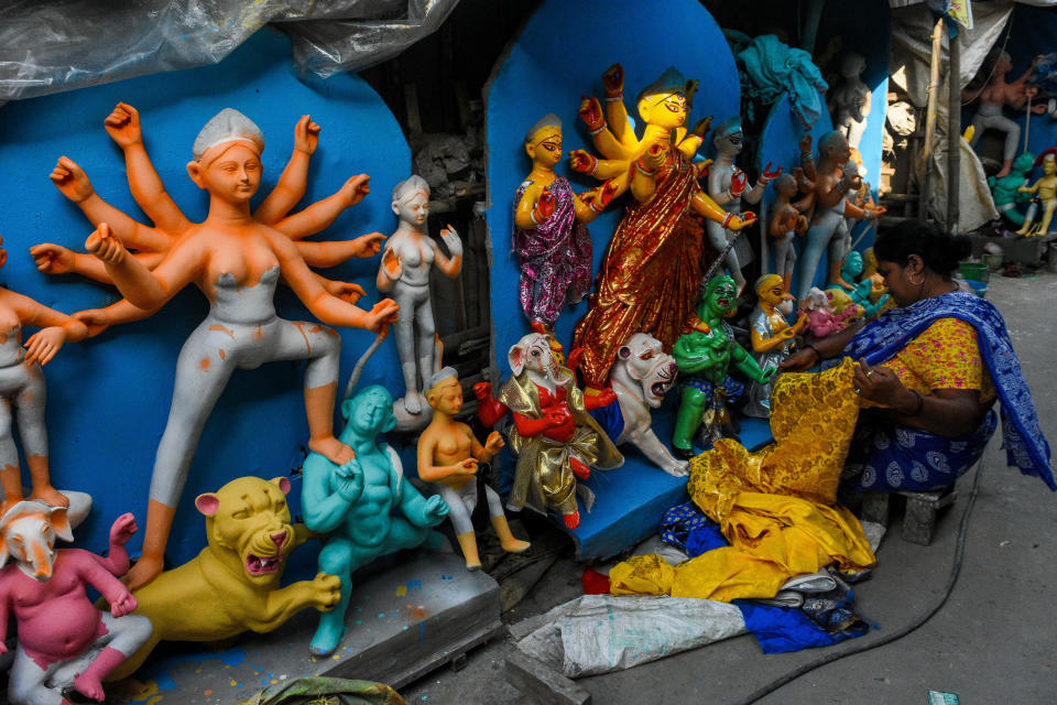 A lady potter giving final touches to an idol of Durga.Various moment of preparation ahead of Durga puja festival in Kolkata , amidst rising cases of COVID-19 in the city. The health department fears a surge of COVID cases post puja and prepares to tackle the surge of patients if proper norms are not followed during the festival time. India today stands as the second worst affected country by COVID-19 in the world (Photo by Debarchan Chatterjee/NurPhoto via Getty Images)