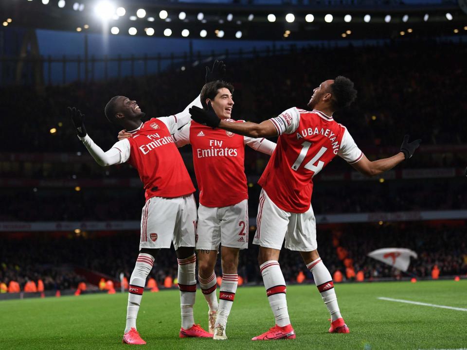 Pierre-Emerick Aubameyang, right, celebrates scoring Arsenal's third: Getty