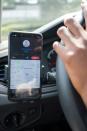 A smartphone displays the information of "Move" app-driven ride-hailing service in the car of Rwandan Joseline Iradukunda as she drives her Volkswagen Polo in Kigali