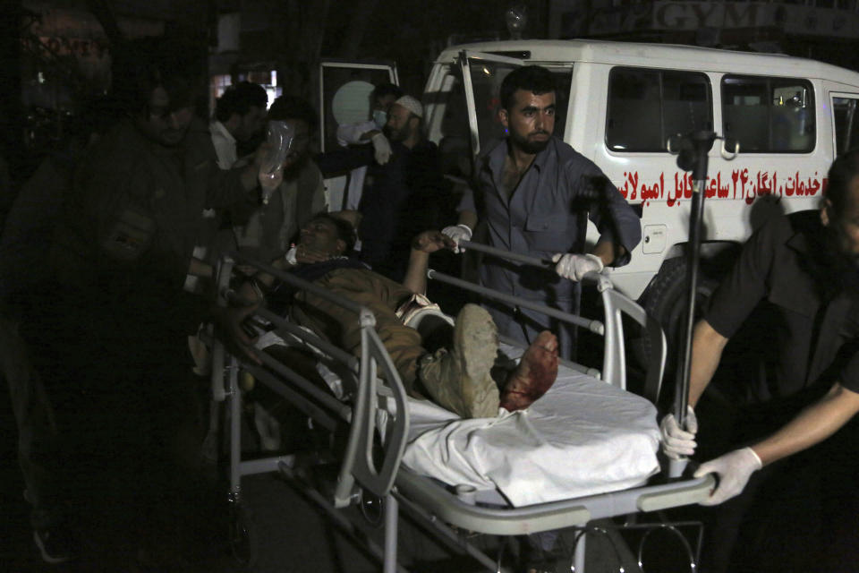 Afghan men carry an injured man into a hospital after a large explosion in Kabul, Afghanistan, Monday, Sept. 2, 2019. Afghan officials say a large explosion in Kabul has targeted the Green Village compound, home to several international organizations and guesthouses. (AP Photo/Rahmat Gul)