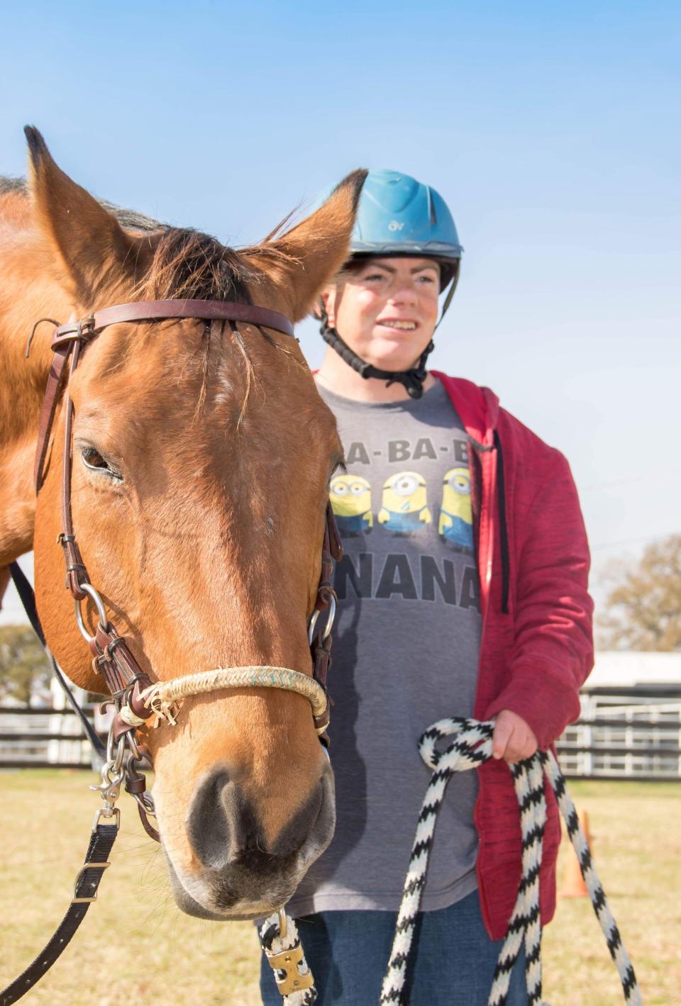 Stephen Gersuk, who is 40 and lives at the Denton State Supported Living Center, stands by a horse at a therapeutic riding center in Aubrey, TX. Staffers from the center take Gersuk to the riding center every Friday.