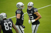 Las Vegas Raiders tight end Jason Witten (82) and end Derek Carrier (85) run a drill during an NFL football training camp practice Friday, Aug. 28, 2020, in Las Vegas. (AP Photo/John Locher)