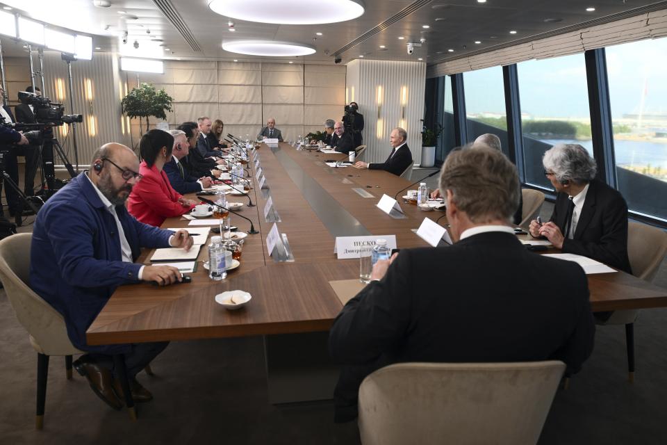 Russian President Vladimir Putin, background right, speaks to senior news leaders of international news agencies on the sidelines of the St. Petersburg International Economic Forum at the Lakhta Center skyscraper, the headquarters of Russian gas monopoly Gazprom in St. Petersburg, Russia, on Wednesday, June 5, 2024. The Russian leader has used the annual forum as a showcase for touting Russia's development and seeking investors. (Vladimir Astapkovich, Sputnik, Kremlin Pool Photo via AP)