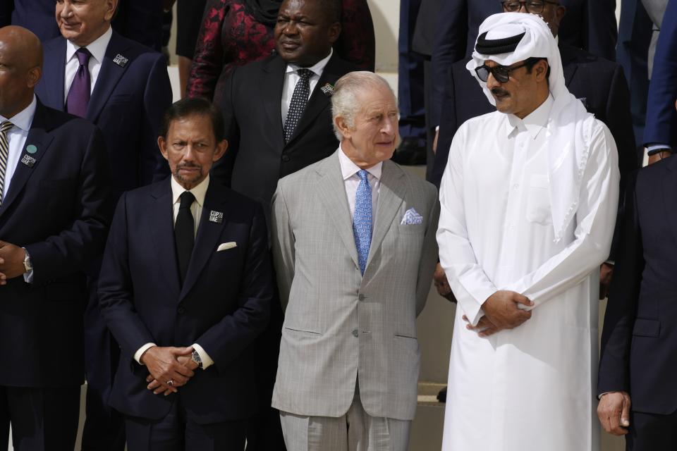 Brunei Sultan Hassanal Bolkiah, left, and King Charles III, center, and Qatar Emir Sheikh Tamim bin Hamad Al Thani attend a group photo at the COP28 U.N. Climate Summit, Friday, Dec. 1, 2023, in Dubai, United Arab Emirates. (AP Photo/Peter Dejong)