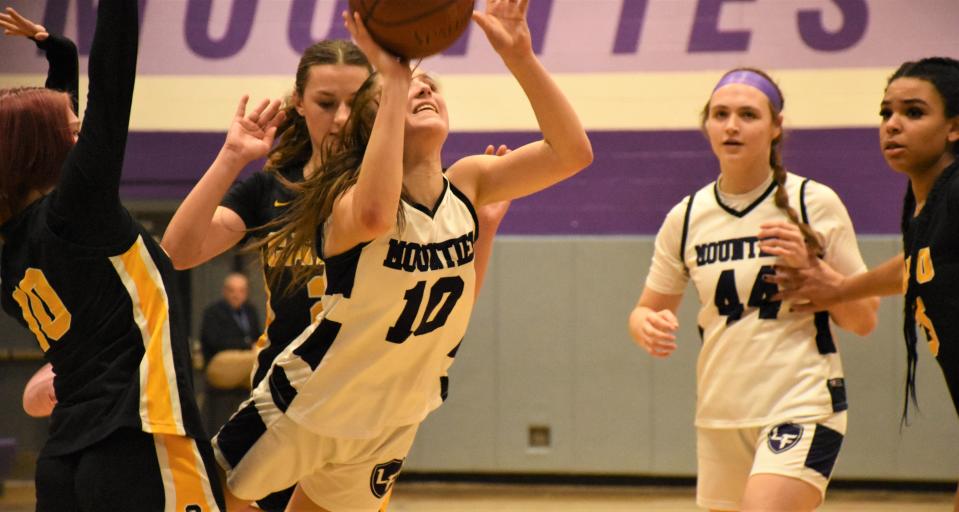 Little Falls Mountie Adriana Izzo (10) attempts an off balance shot after squeezing between Canajoharie defenders Wednesday during the second half of a first round game at the Kasner Klassic.