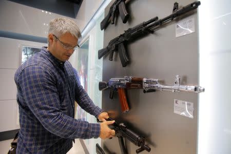 A man browses a model of the Vityaz submachine gun at the newly opened Gunmaker Kalashnikov souvenir store in Moscow's Sheremetyevo airport, Russia, August 22, 2016. REUTERS/Maxim Shemetov