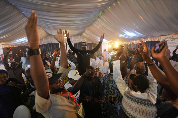 Supporters of Presidential candidate Bola Tinubu of the All Progressives Congress celebrate ahead of the final declaration of election results, at his campaign headquarters in Abuja, Nigeria Wednesday, March 1, 2023. Tensions rose in Nigeria Tuesday as the main opposition parties demanded a revote for the country's presidential election, where the latest results show an early lead for the ruling party. (AP Photo/Ben Curtis)