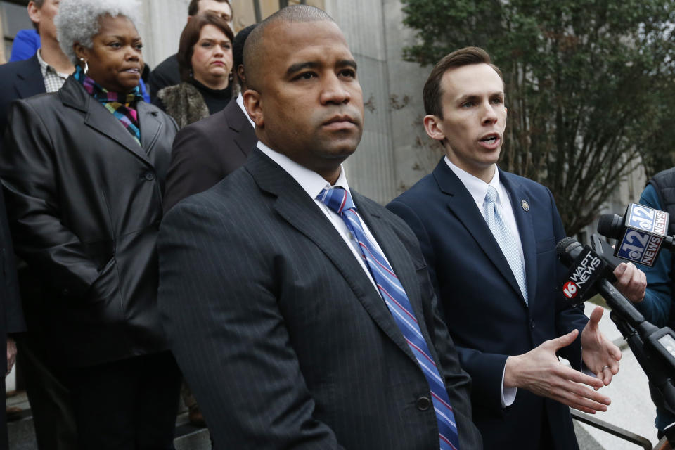 Republican State Auditor Shad White, right, and Hinds County District Attorney Jody Owens discuss the auditor's office investigation of the former director of Mississippi's welfare agency and four other people, accused of embezzling millions in federal money meant for the poor, Thursday, Feb. 6, 2020, in Jackson, Miss. (AP Photo/Rogelio V. Solis)