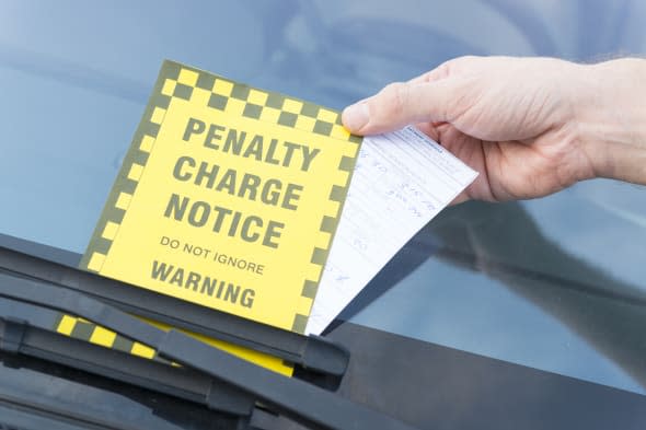 Parking ticket placed under windshield wiper