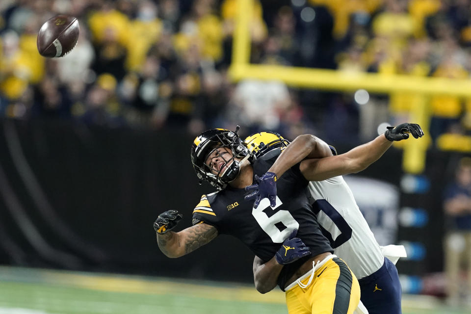 Michigan defensive back Daxton Hill, rear, breaks up a pass intended for Iowa wide receiver Keagan Johnson (6) during the first half of the Big Ten championship NCAA college football game, Saturday, Dec. 4, 2021, in Indianapolis. Hill was called for pass interference on the play. (AP Photo/Darron Cummings)